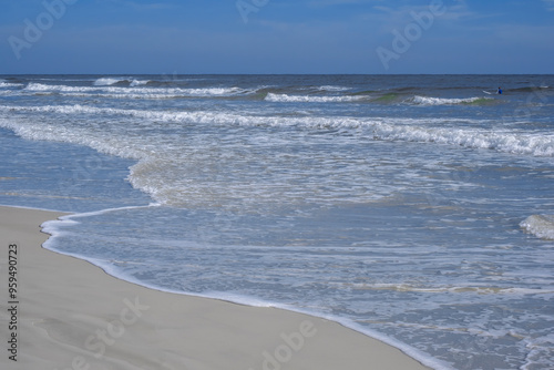 Surfer among the waves, New Smyrna Beach, Florida photo