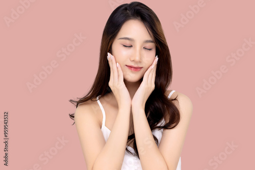 Beautiful young Asian woman with K beauty style makeup and perfect skin on isolated pink background. Facial and skin care concept for commercial advertising.