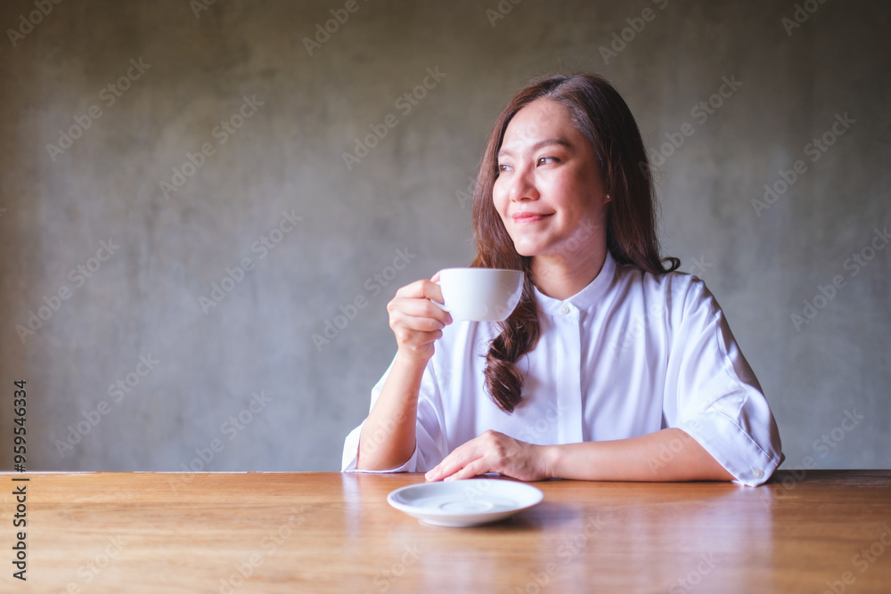 Portrait image of a beautiful young asian woman holding and drinking hot coffee Portrait image of a beautiful young asian woman holding and drinking hot coffee