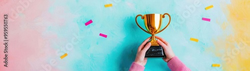 Celebratory moment with a golden trophy held in hands against a colorful background, symbolizing achievement and success.