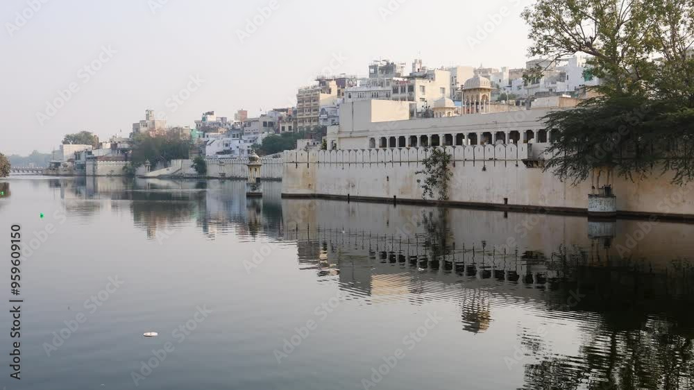 Tranquil Waterfront View of Udaipur Cityscape with Historic Architecture and Reflections Tranquil Waterfront View of Udaipur Cityscape with Historic Architecture and Reflections