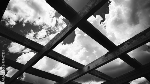 Rafters in construction against clouds photo