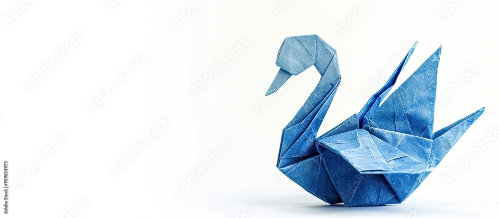 Blue origami swan created from a single sheet of paper without cutting or tearing set against a white background. Copy space image. Place for adding text and design Blue origami swan created from a single sheet of paper without cutting or tearing set against a white background. Copy space image. Place for adding text and design