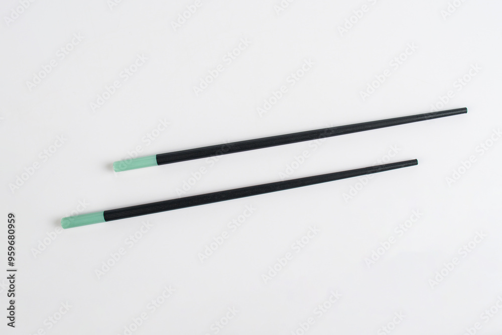 Black chopsticks for rice on a white background Black chopsticks for rice on a white background