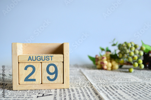 August 29, Calendar cover design with number cube with fruit on newspaper fabric and blue background.	
