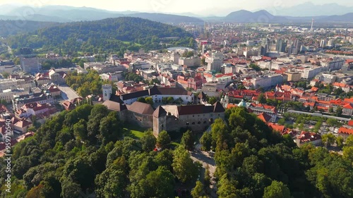 Stunning drone footage of Ljubljana, Slovenia, showcasing the charming old town, the medieval castle, and the vibrant city center with its picturesque streets and unique architecture. photo