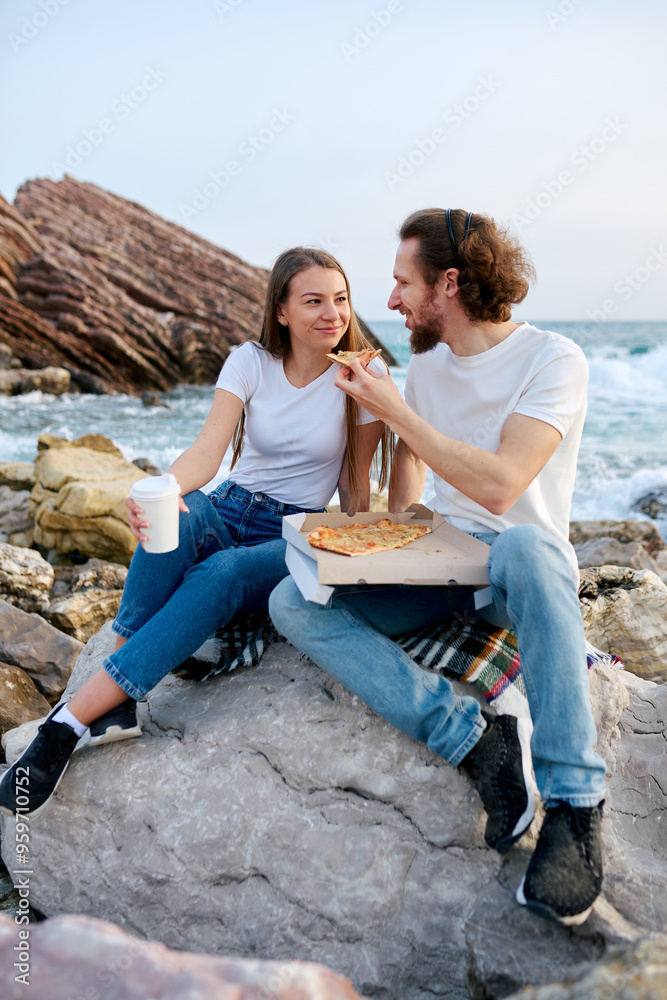 Man and Woman Sitting on Rock Eating Pizza Man and Woman Sitting on Rock Eating Pizza