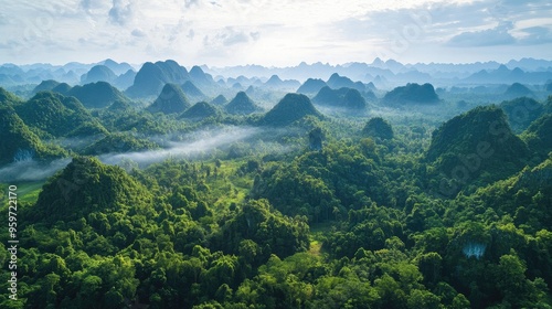 Bird's eye view of the karst formations and dense jungle surrounding the Tham Kong Lo Cave in Khammouane Province. photo