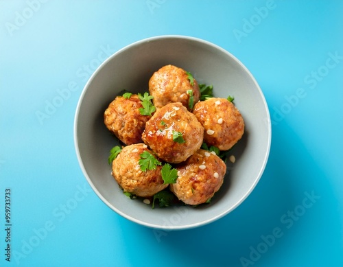 chicken meatballs in bowl on blue background