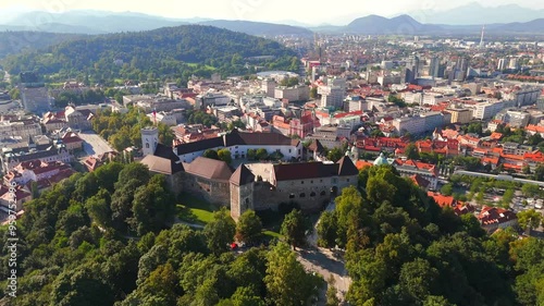 Stunning drone footage of Ljubljana, Slovenia, showcasing the charming old town, the medieval castle, and the vibrant city center with its picturesque streets and unique architecture. photo