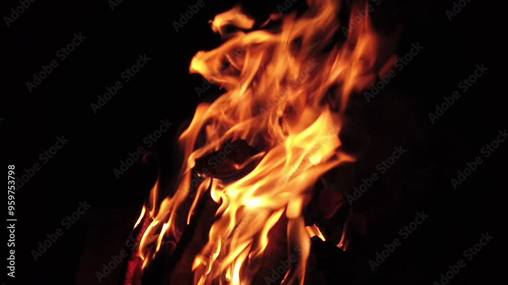 A burning log fire in the night, slow motion capture. A burning log fire in the night, slow motion capture.