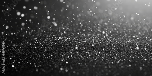 Abstract black background with delicate snowflakes or powdery particles falling and scattering, creating a wintery and textured visual perfect for holiday designs, festive presentations, or creative p