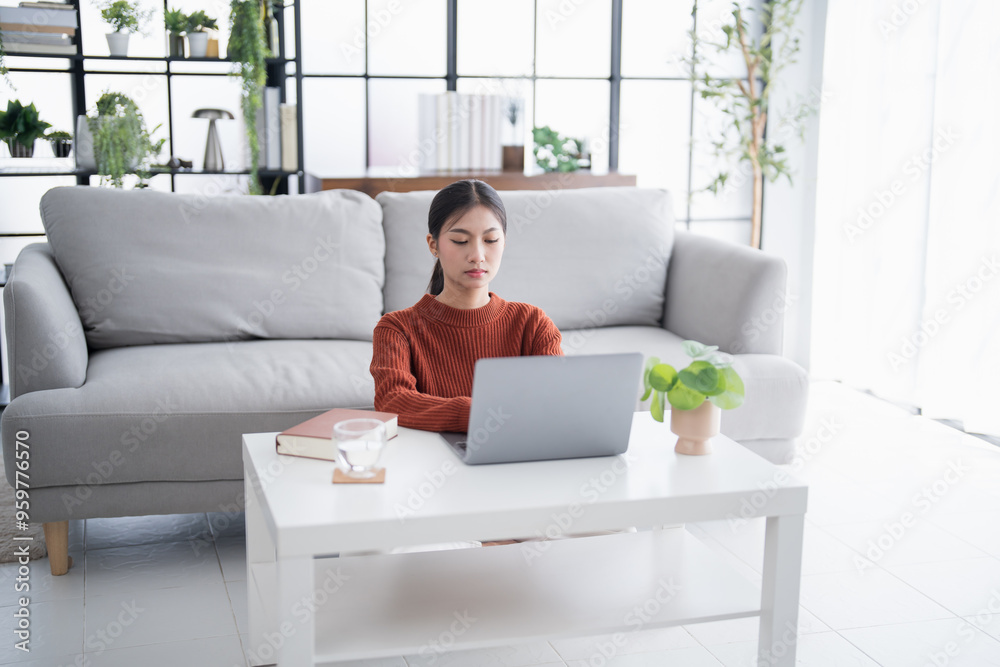 Business woman working from home. work online on laptop. Asian businesswoman working on sofa online business with social distancing laptop online meeting Business woman working from home. work online on laptop. Asian businesswoman working on sofa online business with social distancing laptop online meeting