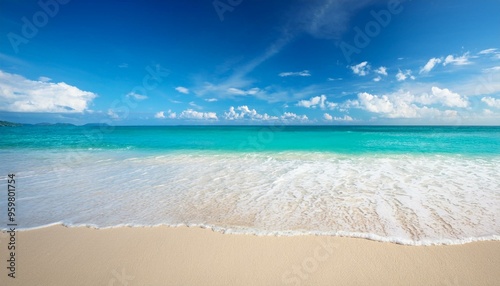 Beautiful sandy beach with white sand and rolling calm wave of turquoise ocean on Sunny day