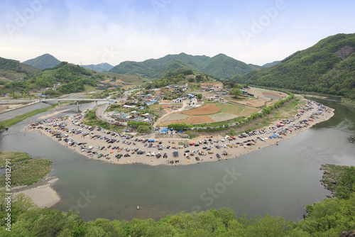 Chungju-si, Chungcheongbuk-do, South Korea - April 24, 2021: High angle view of tourists and cars for camping at Sujupalbong Recreation Area near Dalcheon River photo