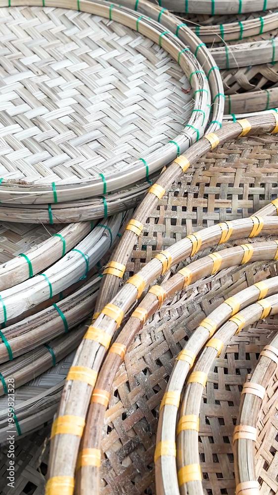 Obraz premium Traditional handmade bamboo trays stacked together, symbolizing Asian craftsmanship and sustainability