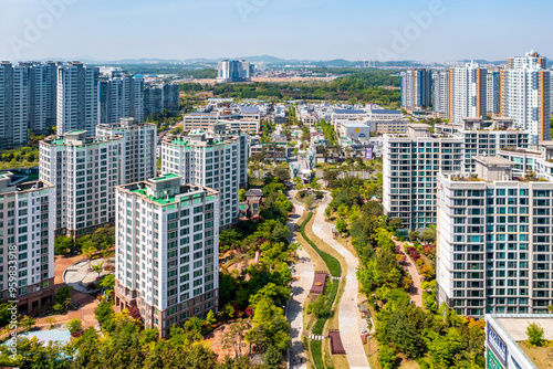 Seo-gu, Incheon, South Korea - May 3, 2021: Aerial view of stream and trees surrounded by high-rise apartments at Cheongna International City photo