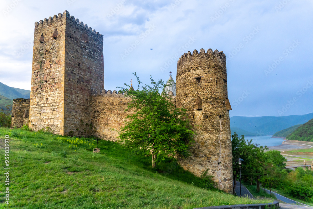Fortress wall and towers of Ananuri complex. Warm evening light, rainy weather Fortress wall and towers of Ananuri complex. Warm evening light, rainy weather