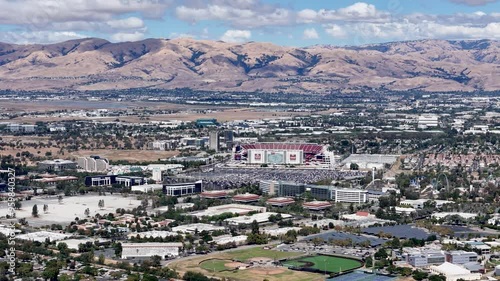 Levi's Stadium aerial view with the surrounding Silicon Valley landscape and distant hills under a clear sky in Santa Clara, California. Perfect for showcasing California's urban and natural scenery