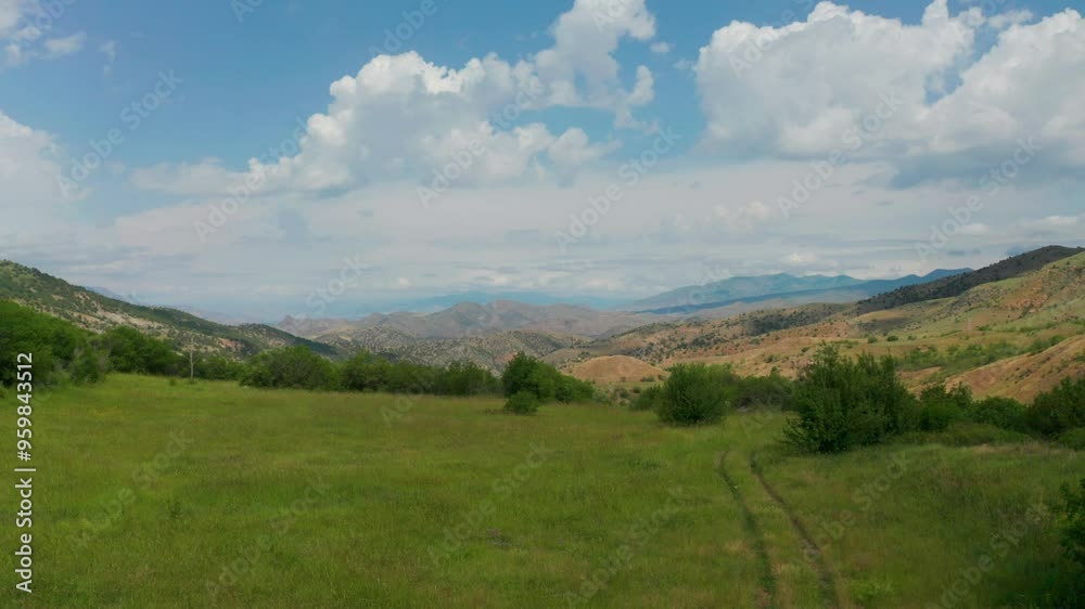 Drone fly over green grass, dessert mountains. Mountains in Vayots province, Armenia, Caucasus. Mountains with white clouds background in Armenia, West Asia. Drone fly over green grass, dessert mountains. Mountains in Vayots province, Armenia, Caucasus. Mountains with white clouds background in Armenia, West Asia.