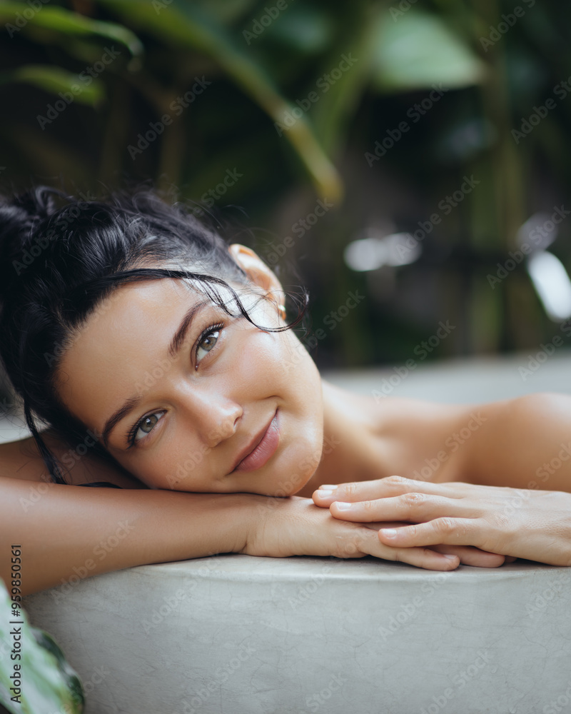 Obraz premium Serene Woman Relaxing in Tropical Spa with Lush Greenery