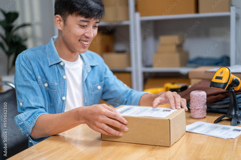 Young Asian man, distributor, online shop owner, small business owner, standing in warehouse and preparing to ship goods, with parcel boxes. Young Asian man, distributor, online shop owner, small business owner, standing in warehouse and preparing to ship goods, with parcel boxes.