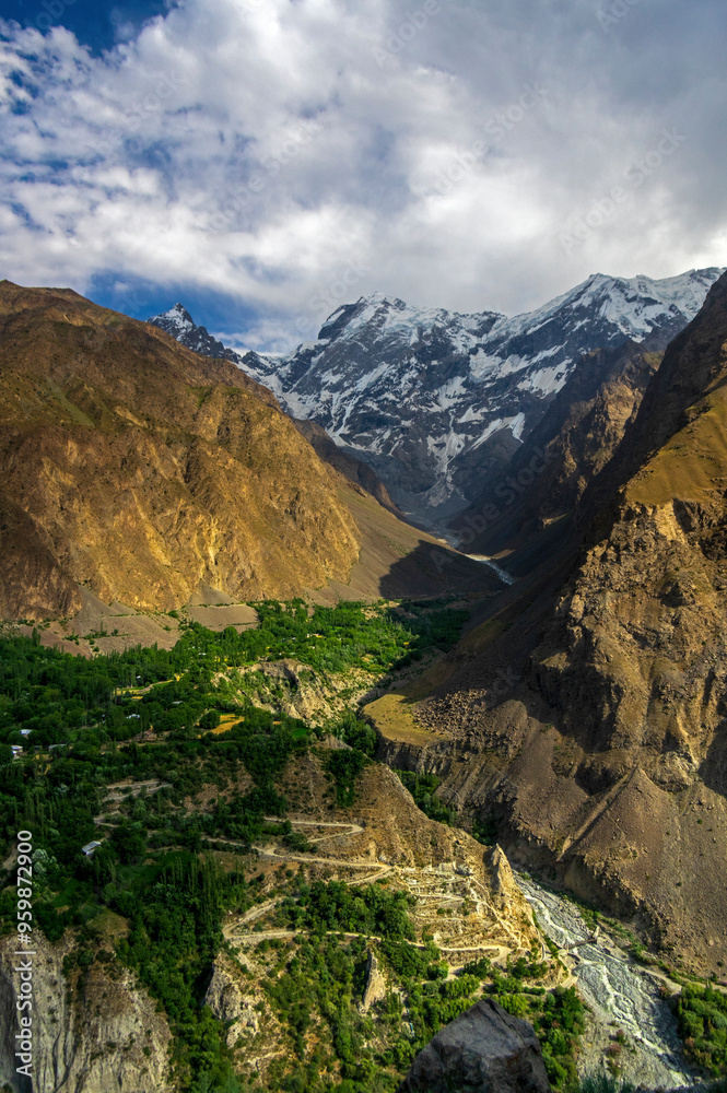 View of majestic snow-capped peaks and lush greenery in a breathtaking valley, Mastuj, Pakistan. View of majestic snow-capped peaks and lush greenery in a breathtaking valley, Mastuj, Pakistan.
