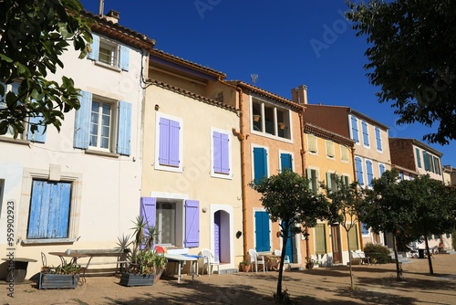 Colourful housefronts in morning sunlight in Mediterranean seaside town of Leucate in Aude department, France  photo