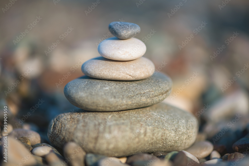 A pyramid of stones on a pebble beach by the sea, the concept of balance, balance, tranquility, relaxation A pyramid of stones on a pebble beach by the sea, the concept of balance, balance, tranquility, relaxation
