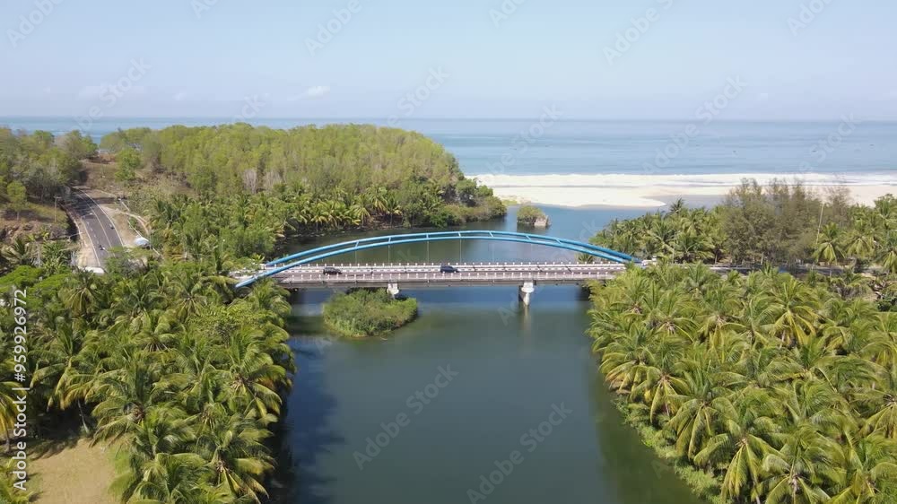Aerial view of Soge Bridge, the bridge located in Pacitan district has a beautiful view of the beach and a large river surrounded by hills. The beauty of Indonesia's charm. Aerial view of Soge Bridge, the bridge located in Pacitan district has a beautiful view of the beach and a large river surrounded by hills. The beauty of Indonesia's charm.