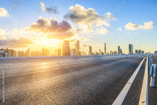 Asphalt highway road and city skyline with modern buildings at sunrise in Shenzhen. car advertising background.