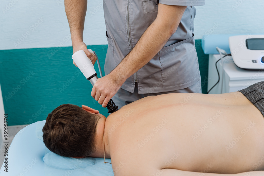 Shockwave therapy session for back pain relief in a clinical setting with a professional therapist Shockwave therapy session for back pain relief in a clinical setting with a professional therapist