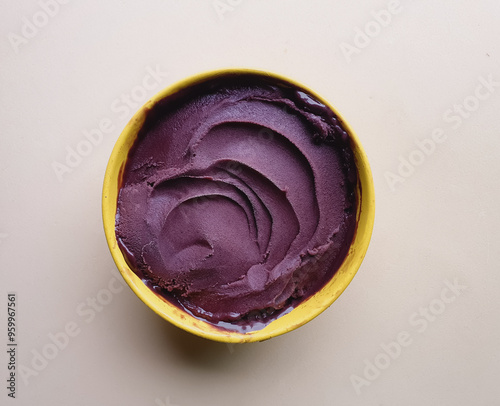 iced and creamy açai in yellow bowl and beige background