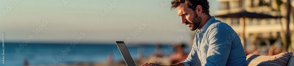 Digital Nomad Working on His Laptop Outdoors from the Beach Digital Nomad Working on His Laptop Outdoors from the Beach