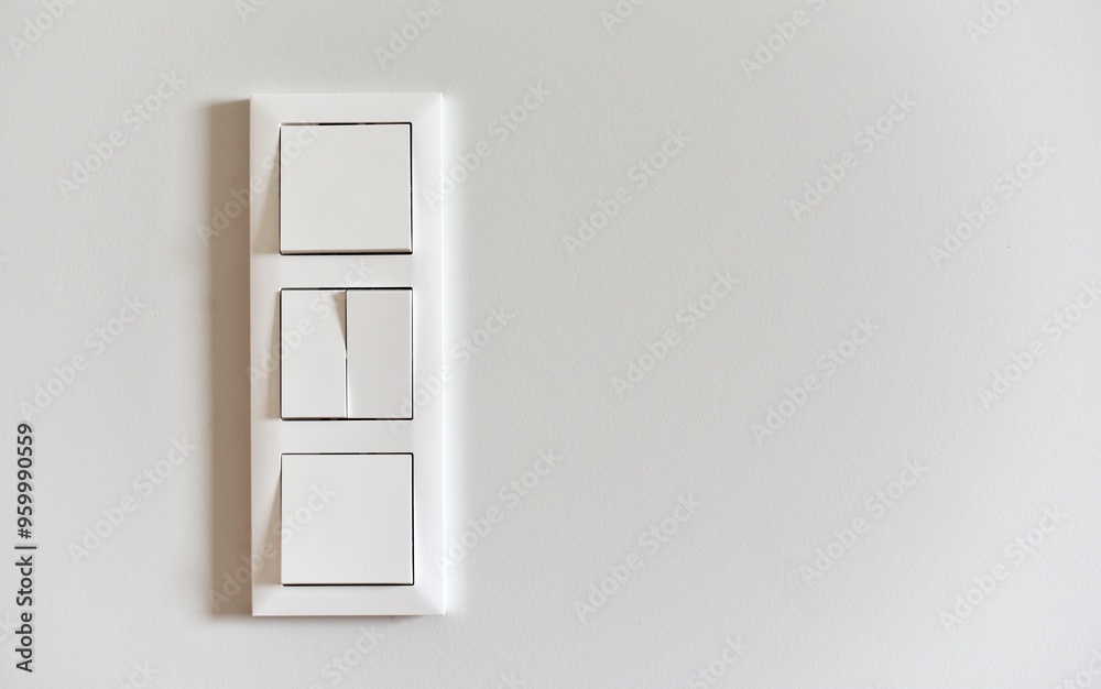 White switch on a light wall White switch on a light wall