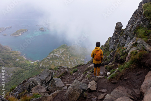 Children and adults, happy family with dog, climbing Festvagtinden via Heiavatnet trail in Norway photo