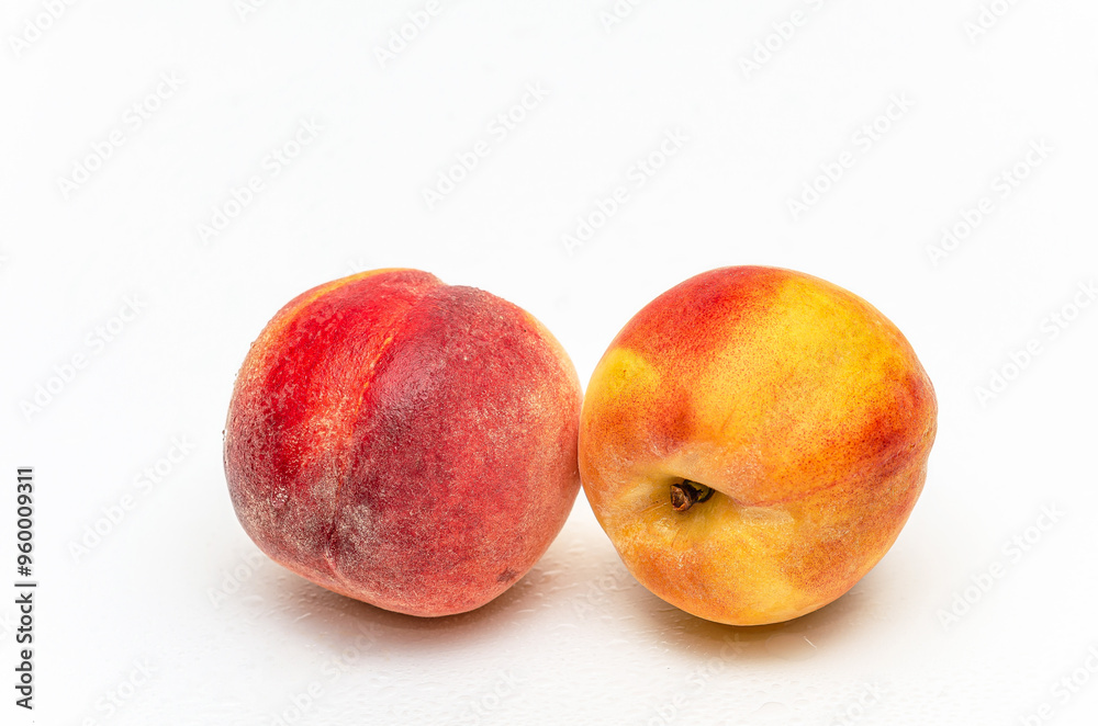 Two wet ripe peaches with water drops. Isolated on white background. Production juice. Copy space. Two wet ripe peaches with water drops. Isolated on white background. Production juice. Copy space.