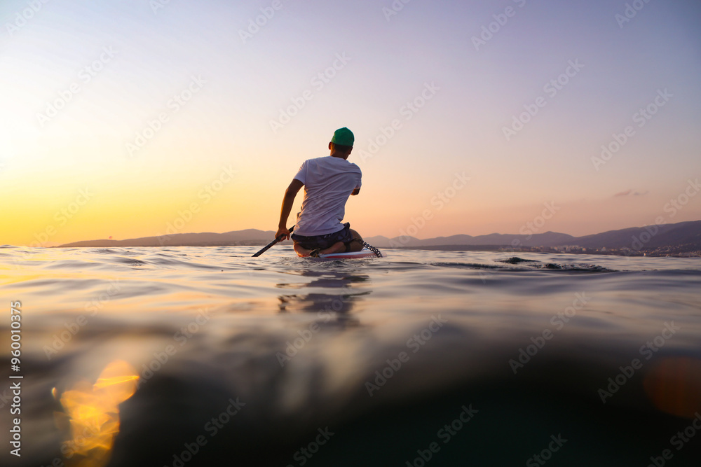sup surfing in the sea