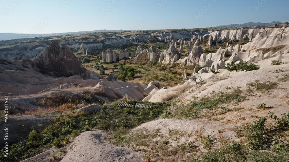 Rocky landscape of Cappadocia with unique formations under clear skies on a sunny day Rocky landscape of Cappadocia with unique formations under clear skies on a sunny day