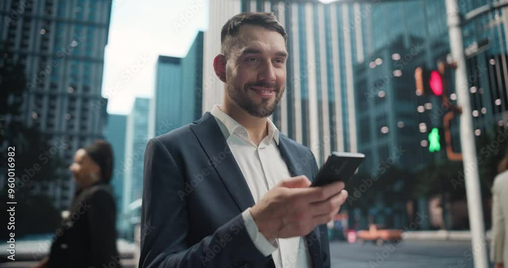 Businessman in a Navy Blazer Using Smartphone while Walking Through a Modern City Street with Skyscrapers. Successful Businessman Checking Stock Market Trading Software and Daily Updates from Work Businessman in a Navy Blazer Using Smartphone while Walking Through a Modern City Street with Skyscrapers. Successful Businessman Checking Stock Market Trading Software and Daily Updates from Work