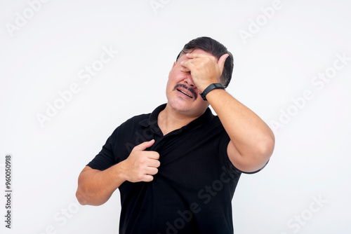 A middle aged man feeling both chest pain and a headache. Grimacing in pain or discomfort. Signs of advanced hypertension. Isolated on a white background. photo