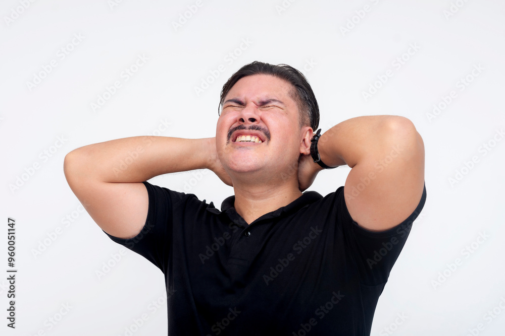A middle aged man suffering from a sore or stiff neck. Throbbing at the back of his head. Isolated on a white background. A middle aged man suffering from a sore or stiff neck. Throbbing at the back of his head. Isolated on a white background.