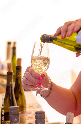 White sparkling wine pouring into a wine glass