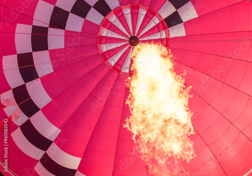 A view of the interior of a flying balloon with a lit torch flame