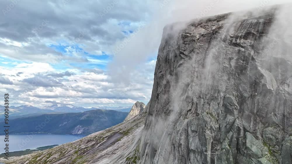 Clouds and fog rolling over mountain tops in Efjord in Northern Norway