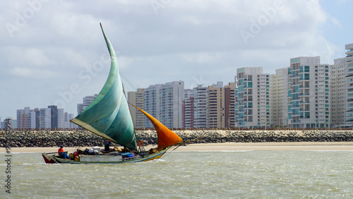 Sailing Through Time: Traditional Fishing Boat Amidst Sao Luis Skyscrapers - A Colorful Contrast of Tradition and Modernity