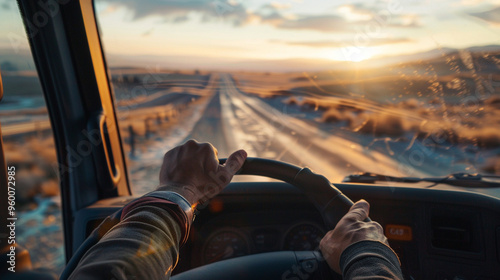 Medium close-up of the truck driverâs hand feeling the cool breeze from the open window during a long drive.