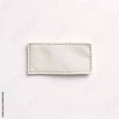 Minimalist cloth label mockup with no text, lying flat on a smooth white background