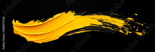 bright yellow brush stroke of paint on black background
