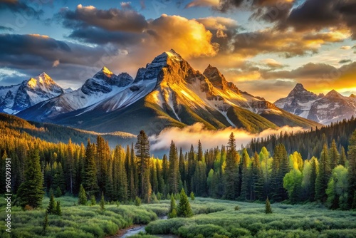 Serene sunrise casts golden light on rugged snow-capped peak, accentuating dramatic ridgelines and valleys, with verdant forests sprawling in the distant misty landscape below. photo